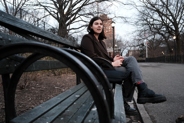 young woman seated on park bench