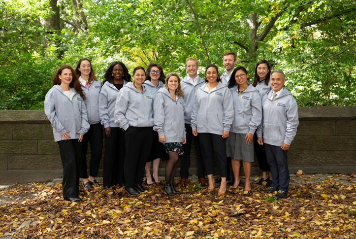Group of Harkness fellows in park in sweatshirts