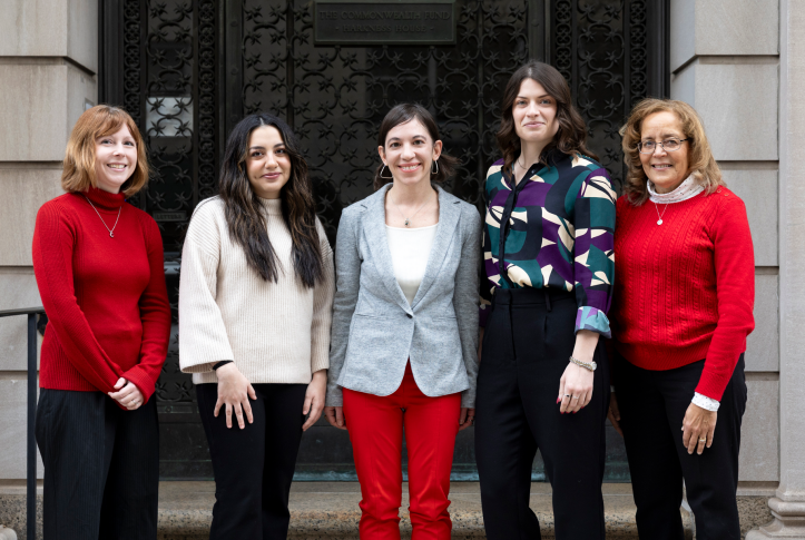 Five women posing for a photo standing in front of the Commonwealth Fund building