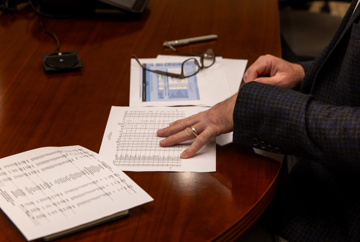 Man’s hand flipping through tax documents