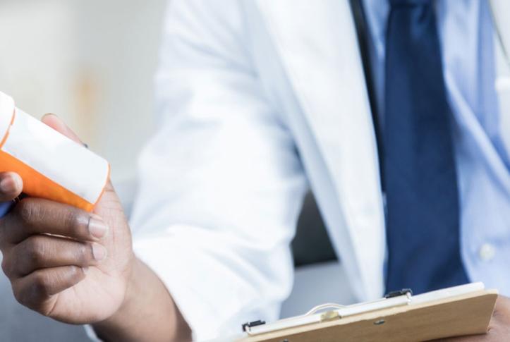 Doctor giving out drugs to patient