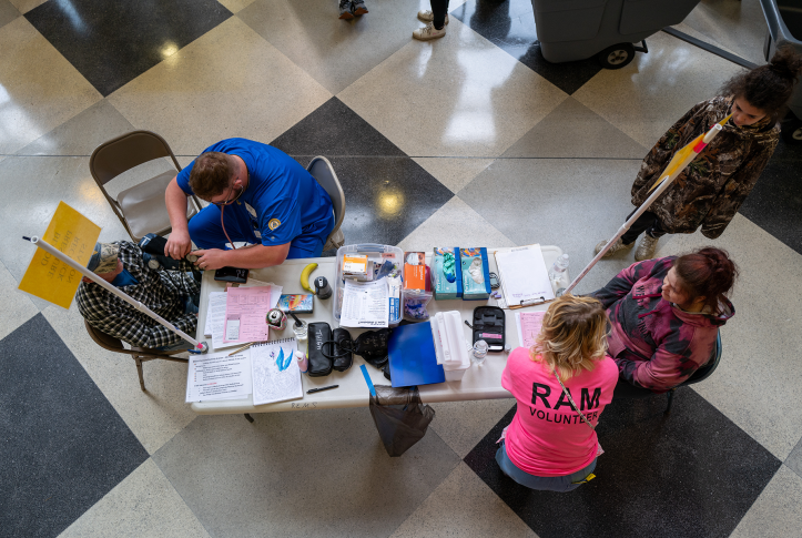 Overhead look at blood pressure being taken at fold up table