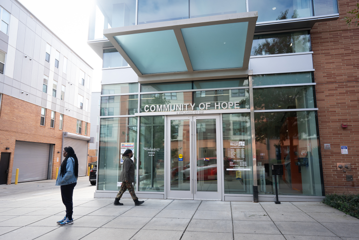 Pregnant patients walk in front of community health center entrance