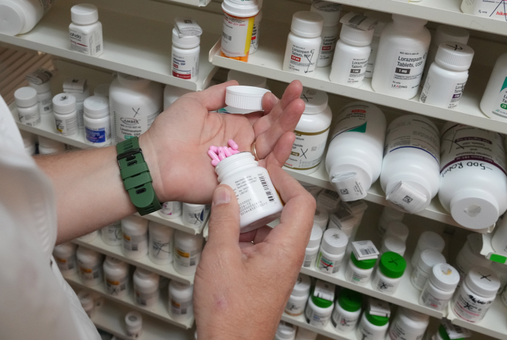 Pills pour into a hand at the pharmacy