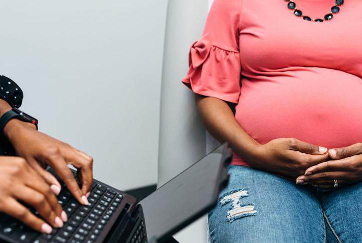 black pregnant woman getting doctor checkup