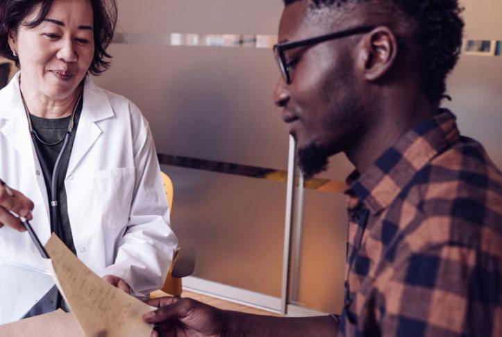 doctor consults with patient in office