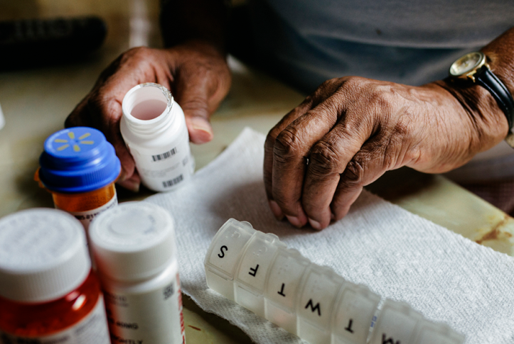 patient laying out prescription drugs for the week