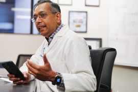 Doctor talks with phone in hand