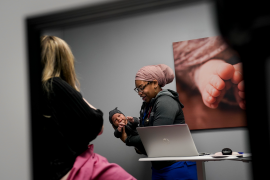 Woman holds baby in doctors office